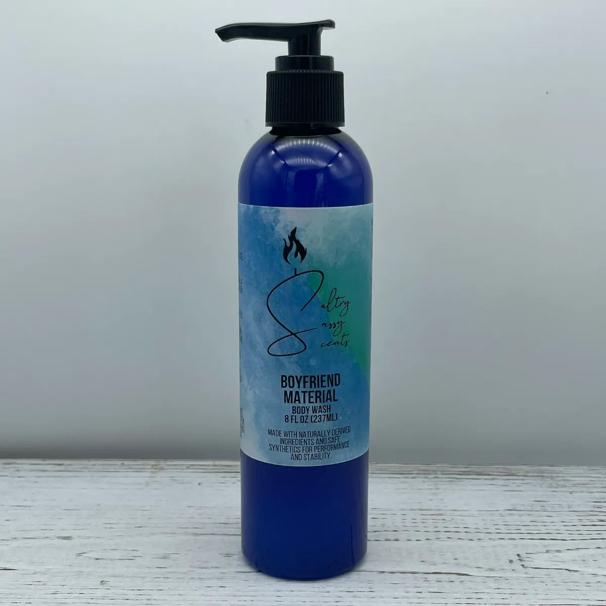 Front label view of a large 8-ounce blue pump bottle containing Sultry Sassy Scents "Boyfriend Material" Body Wash, positioned against a crisp light gray background.