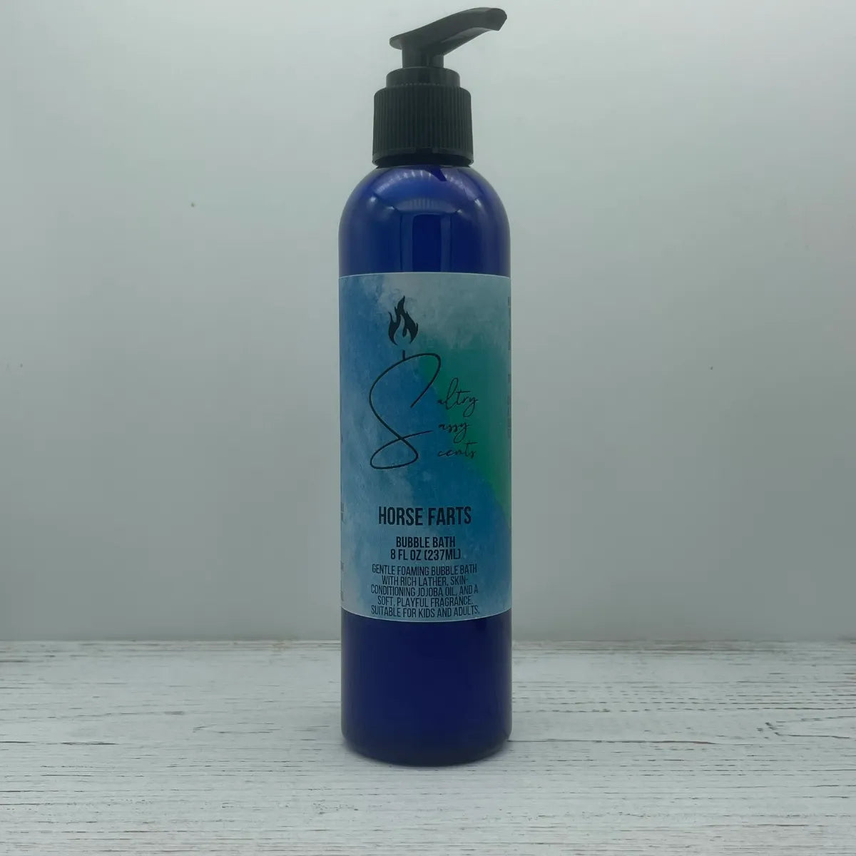 Front label view of a large 8-ounce blue pump bottle containing Sultry Sassy Scents "Horse Farts" Bubble Bath, highlighting the gentle foaming formula description.
