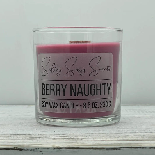 An 8.5-ounce jar of Sultry Sassy Scents "Berry Naughty" soy wax candle featuring a rich dark pink wax color, centered against a light gray background.